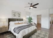 Thumbnail 33 of 48 - the master bedroom has a large bed and a ceiling fan