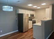 Thumbnail 28 of 35 - a kitchen with white cabinets and a black refrigerator