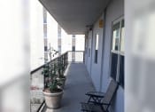 Thumbnail 3 of 15 - a balcony with a chair and plants on it