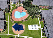 Thumbnail 26 of 27 - A bird's eye view of a residential area with a swimming pool and a blue pavilion.