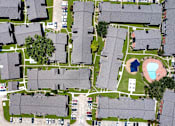 Thumbnail 20 of 26 - A bird's eye view of a neighborhood with houses, cars, and a playground.