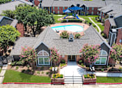 Thumbnail 19 of 26 - A bird's eye view of a residential area with houses, a pool, and a playground.