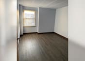Thumbnail 20 of 22 - an empty room with wood floors and a window