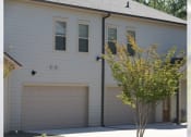 Thumbnail 5 of 16 - the front of a white house with two garage doors