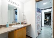 Thumbnail 10 of 34 - a bathroom with a sink and a mirror and a shower