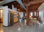 Thumbnail 12 of 34 - a large kitchen with stainless steel appliances and a dining table