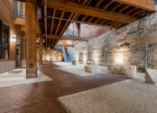Thumbnail 13 of 34 - the interior of a building with stone walls and wood beams