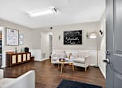 Thumbnail 4 of 31 - A room with a white couch and a chalkboard on the wall.