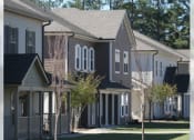Thumbnail 3 of 16 - a row of houses with trees in front of them