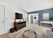 Thumbnail 10 of 31 - A living room with a flat screen TV and a wooden cabinet.