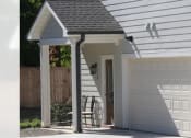 Thumbnail 1 of 16 - the front of a white garage with a white door