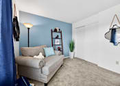 Thumbnail 25 of 31 - A grey couch with a white pillow and a white teddy bear on it.