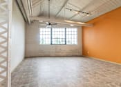 Thumbnail 8 of 16 - A room with orange walls and a window with a fan.