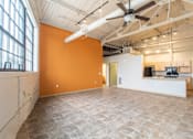 Thumbnail 3 of 16 - A room with orange walls and a ceiling fan.