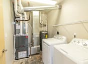 Thumbnail 6 of 16 - A bathroom with a washer and dryer in it.