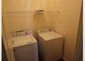 Thumbnail 12 of 16 - a room with a washing machine and a washer and dryer