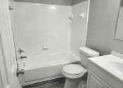 Thumbnail 15 of 15 - an empty bathroom with a toilet and a bath tub