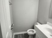 Thumbnail 14 of 15 - an empty bathroom with a toilet and a sink