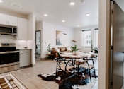Thumbnail 1 of 22 - A modern kitchen with a dining table set for four.
