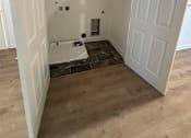 Thumbnail 9 of 9 - A white refrigerator is installed in a room with wooden walls.