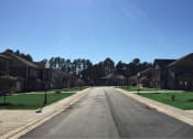 Thumbnail 15 of 16 - a street with rows of houses on either side of a road