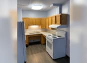 Thumbnail 19 of 22 - an empty kitchen with a stove refrigerator and sink