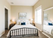 Thumbnail 1 of 39 - a bedroom with a large bed and a large mirror at Metro67, Memphis, TN