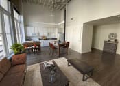 Thumbnail 7 of 9 - an open living room with a kitchen and dining area  at Lofts at Union Alley, Memphis, 38103