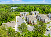 Thumbnail 6 of 6 - A bird's eye view of a residential area with a parking lot and buildings.