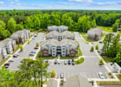 Thumbnail 2 of 6 - A bird's eye view of a residential area with houses and cars.