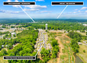Thumbnail 6 of 7 - An aerial view of a residential area with Timber Ridge Cottages 390 Heartwood Lane Spindale.