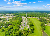 Thumbnail 4 of 7 - A bird's eye view of a residential area with a large water tower in the center.