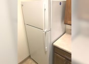 Thumbnail 8 of 15 - a white refrigerator in the corner of a kitchen