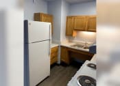Thumbnail 6 of 22 - a kitchen with a white refrigerator and a stove