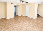Thumbnail 5 of 6 - A room with a ceiling fan and tile flooring.