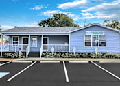 Thumbnail 22 of 25 - A blue building with a sign that says Leasing Center.
