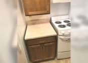 Thumbnail 11 of 15 - a small kitchen with a stove and a refrigerator