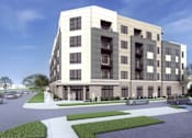 Thumbnail 1 of 4 - A modern apartment building with a parking lot in front.