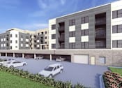 Thumbnail 3 of 4 - A modern apartment building with a parking lot in front.