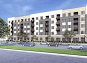 Thumbnail 2 of 4 - A modern apartment building with cars parked in front.
