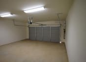 Thumbnail 9 of 16 - the inside of a garage with a garage door