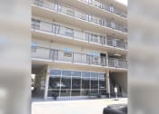 Thumbnail 9 of 15 - a view of an apartment building with glass doors and windows
