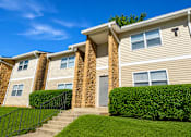 Thumbnail 18 of 18 - A row of houses with a green lawn in front.