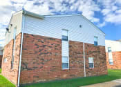 Thumbnail 13 of 17 - the side of a brick building with white siding