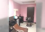 Thumbnail 2 of 15 - a salon room with pink walls and a chair and a sink