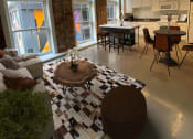 Thumbnail 1 of 9 - a living room and kitchen with a checkered floor at Lofts at Union Alley, Memphis