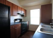 Thumbnail 6 of 16 - a kitchen with a sink a stove and a refrigerator