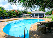 Thumbnail 3 of 33 - a swimming pool with a house in the background