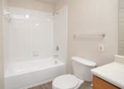Thumbnail 15 of 33 - a bathroom with a toilet and a tub and a sink
