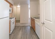Thumbnail 18 of 33 - an empty kitchen with white appliances and wood floors